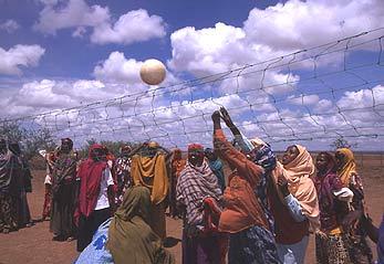 An image of Somali refugee girls at the Hartisheik camp in Ethiopia enjoying a game of volleyball.