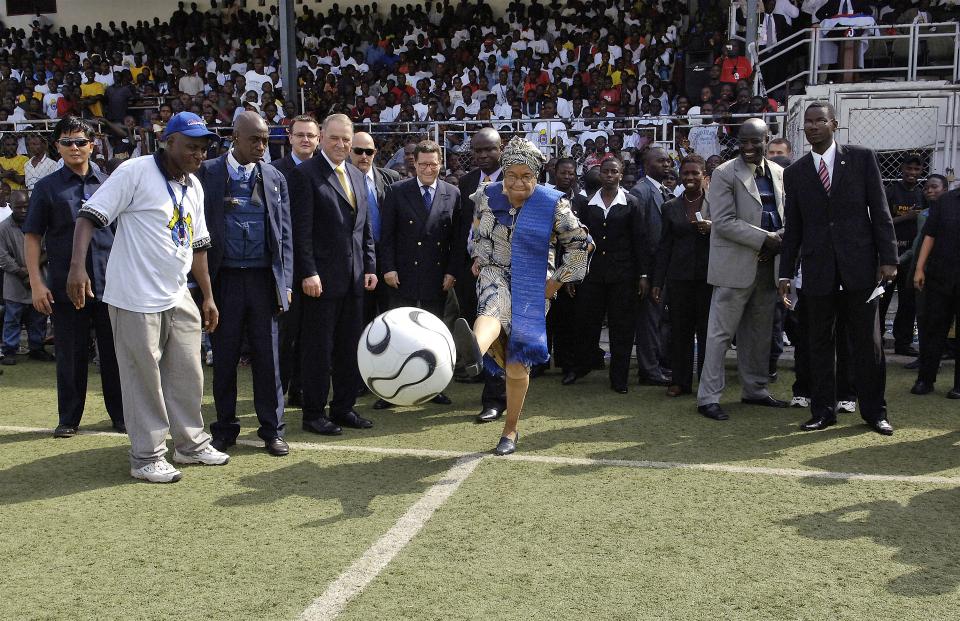 Ellen Johnson-Sirleaf, President of Liberia, kicks a soccer ball to mark the start of the event